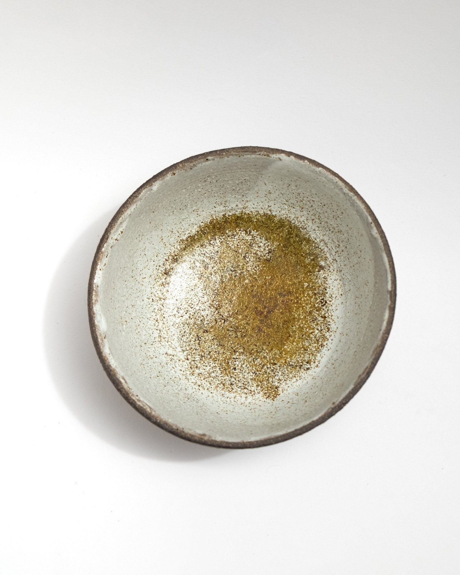 Ceramic bowl with a textured surface on a white background