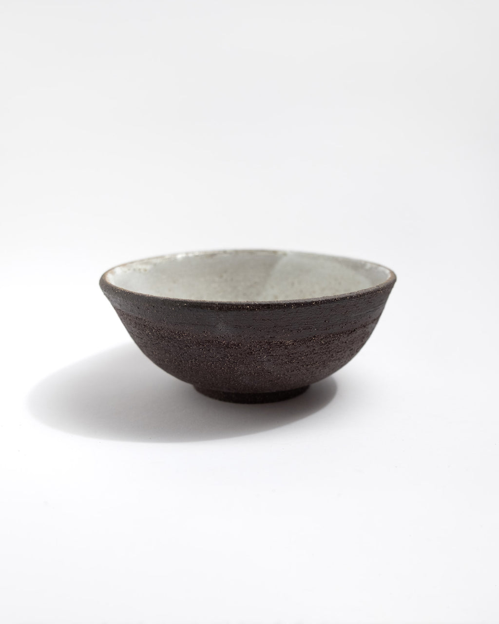Ceramic handmade bowl with a black textured surface