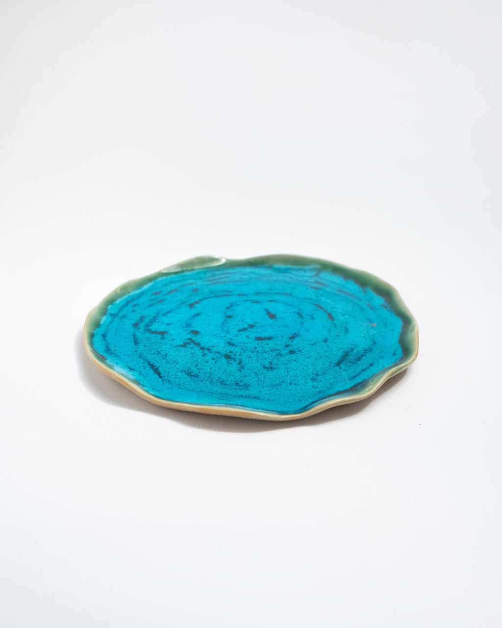Turquoise ceramic plate with green rim