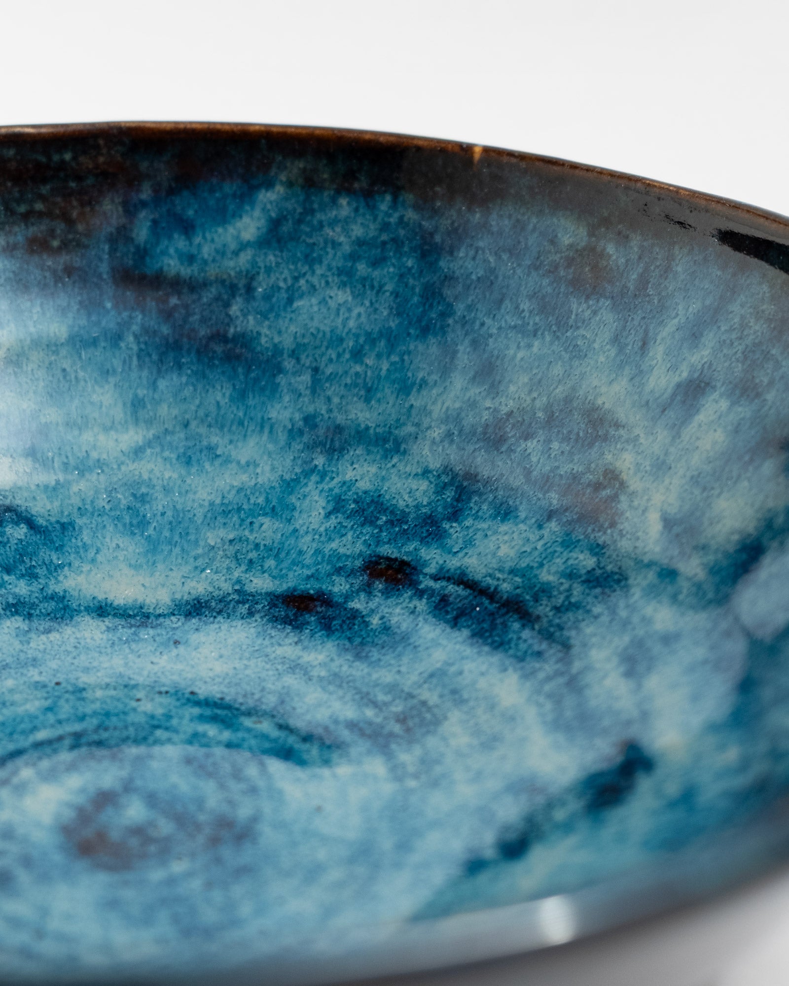 Close-up of a ceramic bowl with blue glaze, handmade in Italy