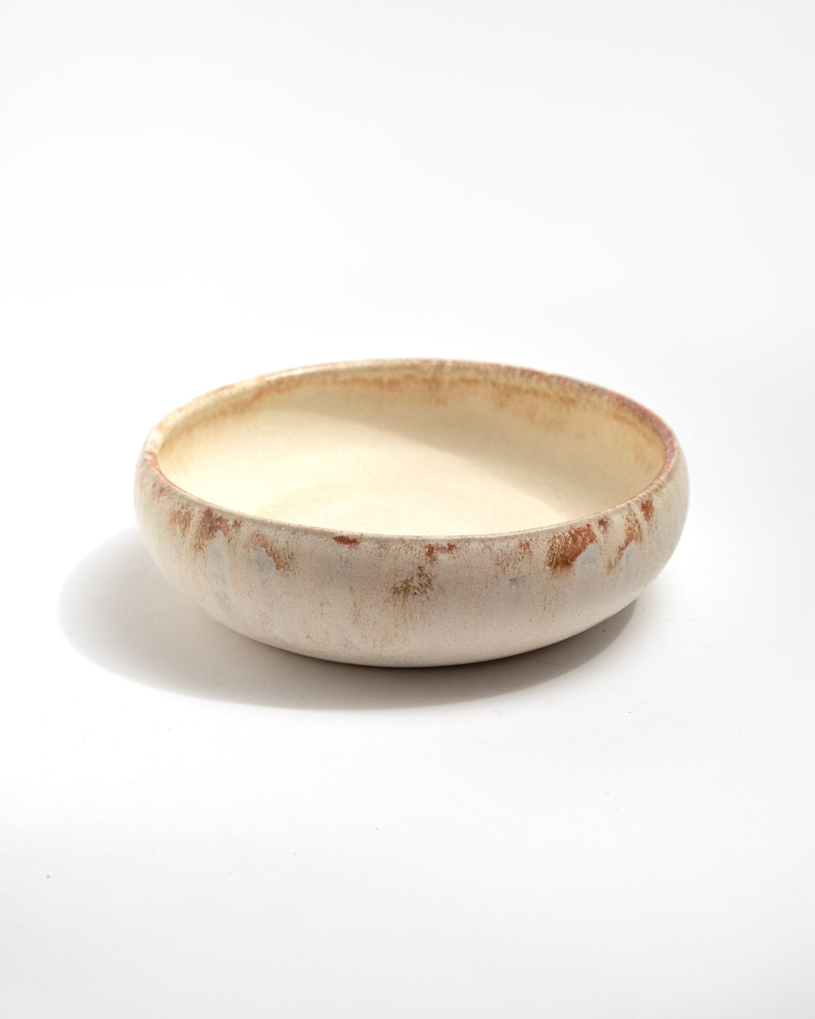 Ceramic bowl with a textured surface on a white background, handmade in Italy