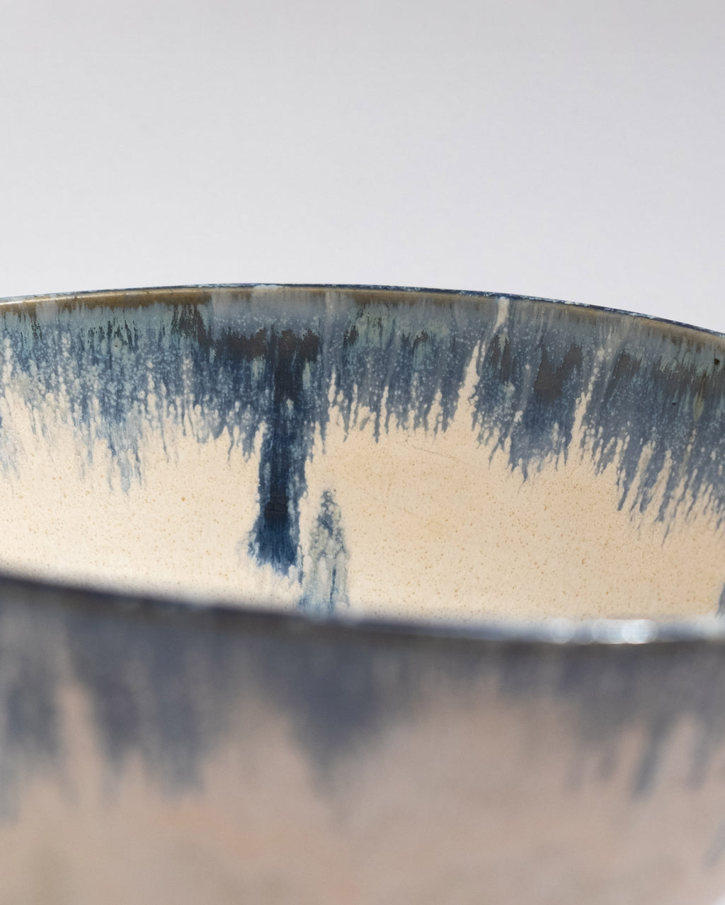 Close-up of a ceramic bowl with blue and white glaze