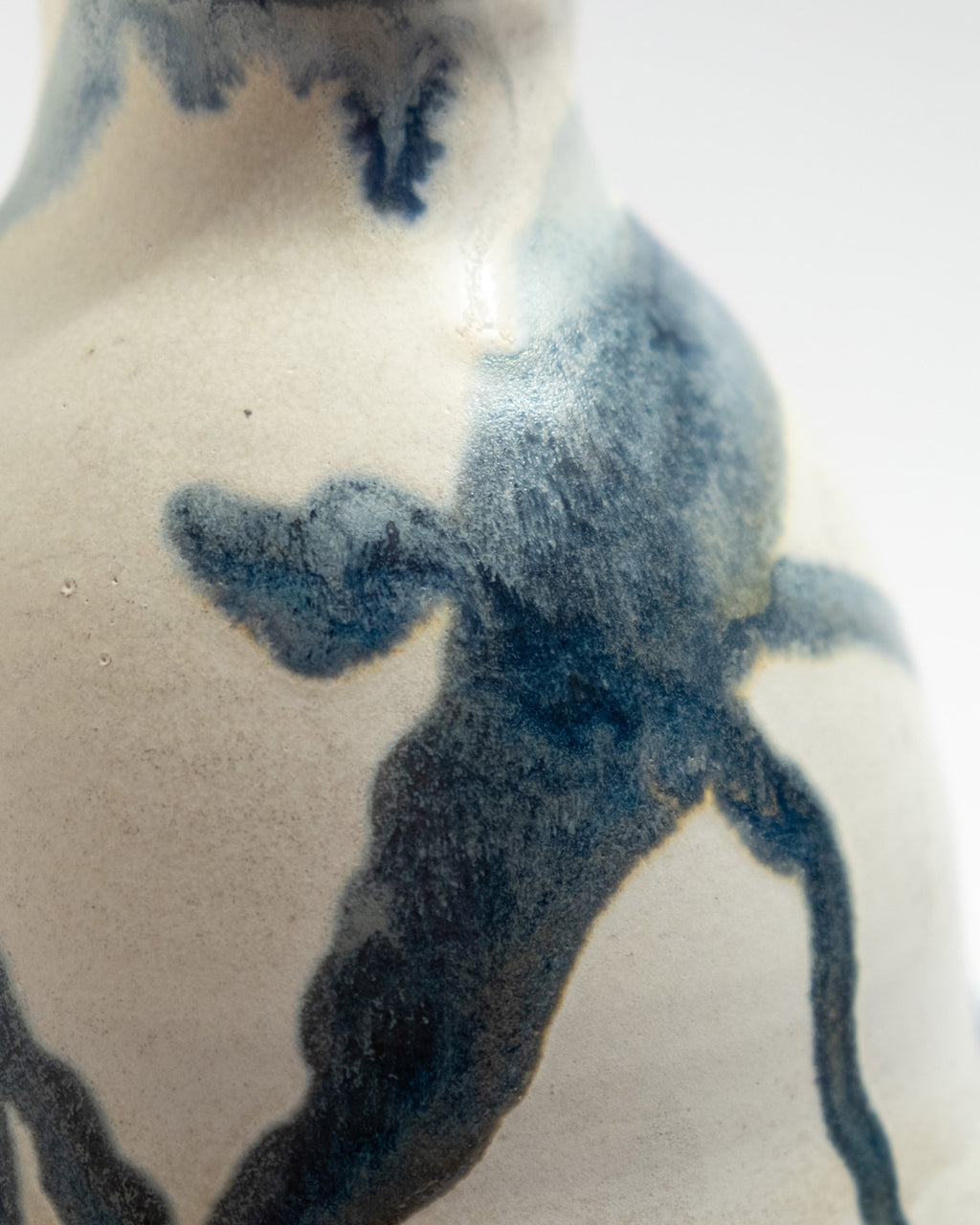 Ceramic vase with blue abstract design on a white background