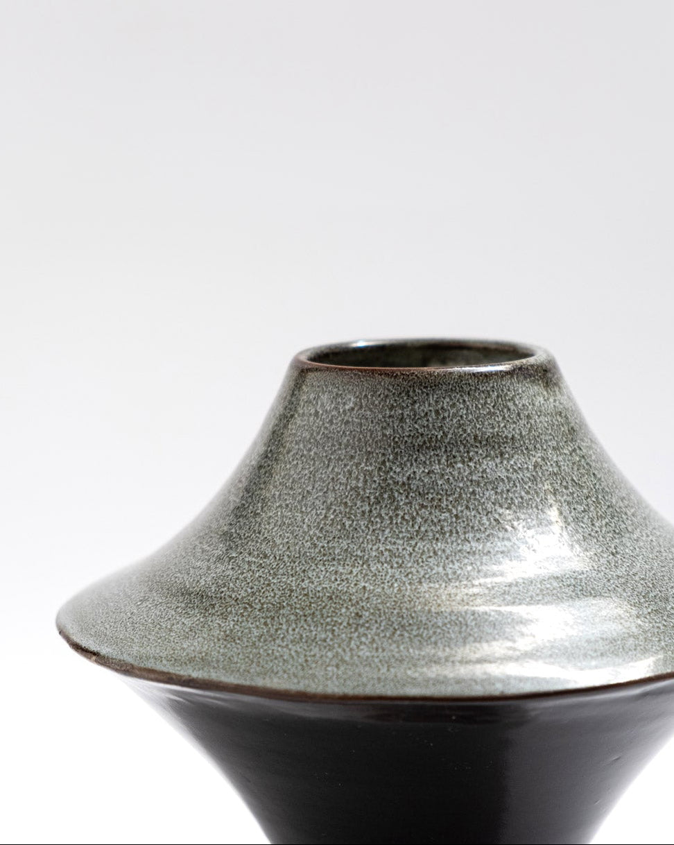 Ceramic vase with a textured surface on a white background