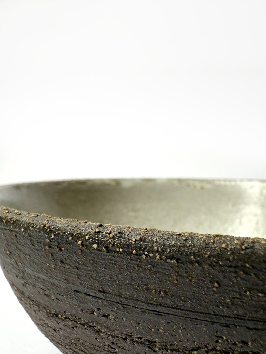 Close-up of a black ceramic bowl on a white background