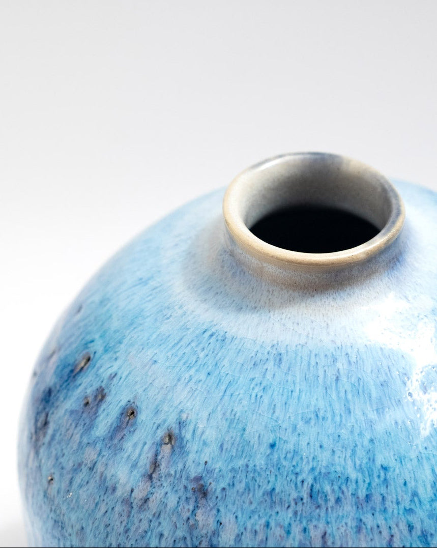 Blue ceramic vase on a white background