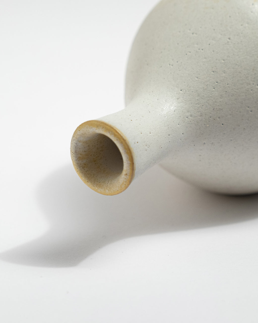 Close-up of a ceramic vase with a smooth surface on a white background