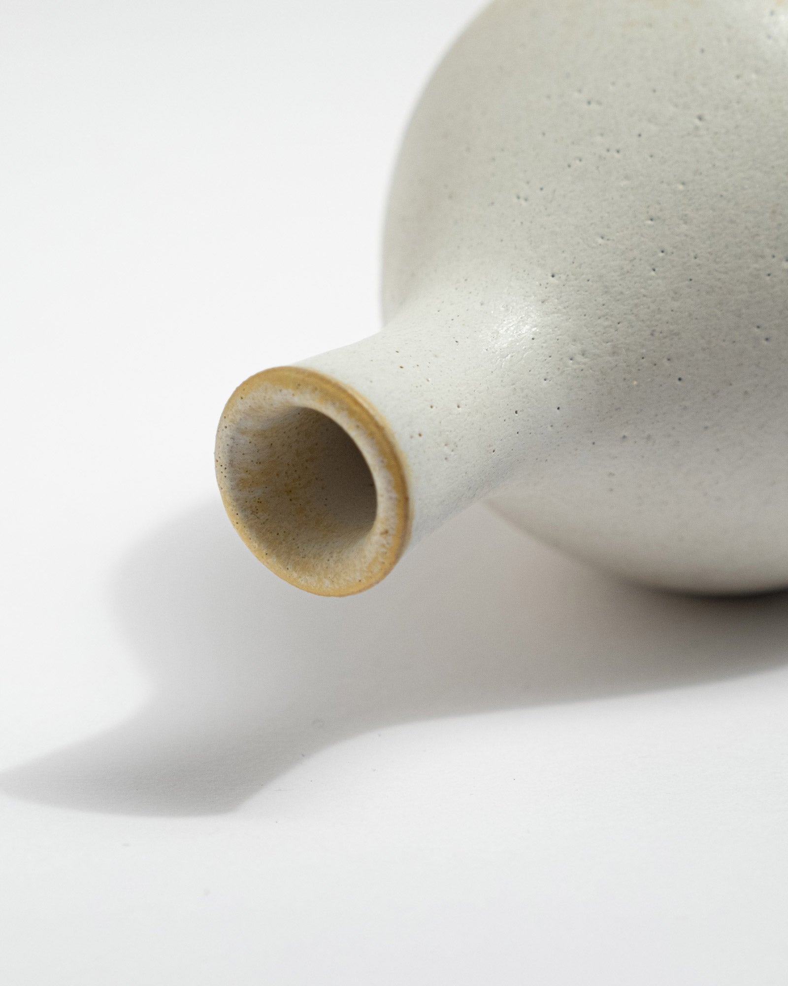 Close-up of a ceramic vase with a smooth surface on a white background