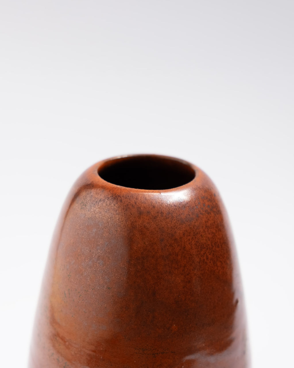Brown red handmade ceramic vase on a light gray background, made in Italy