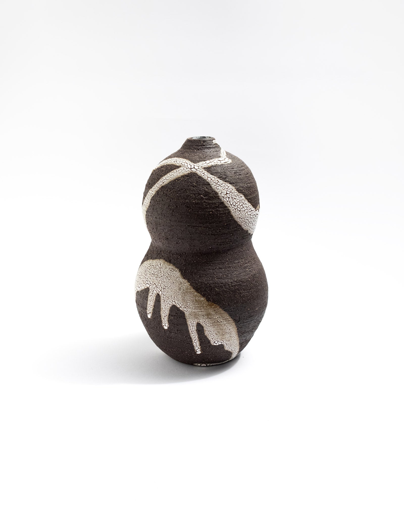 Decorative vase, black clay with white splashes on a white background, handmade in Italy