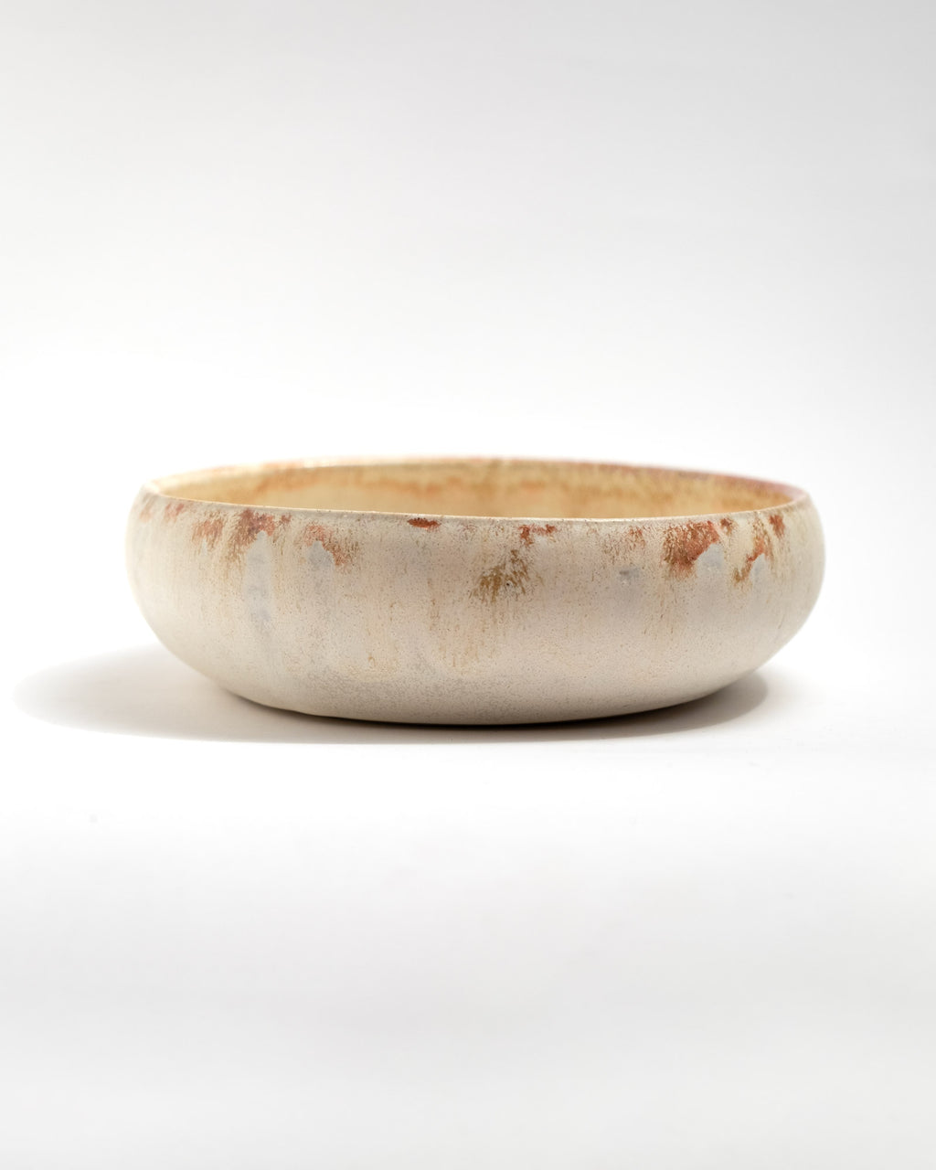 Ceramic bowl with a rustic finish on a white background, handmade in Italy