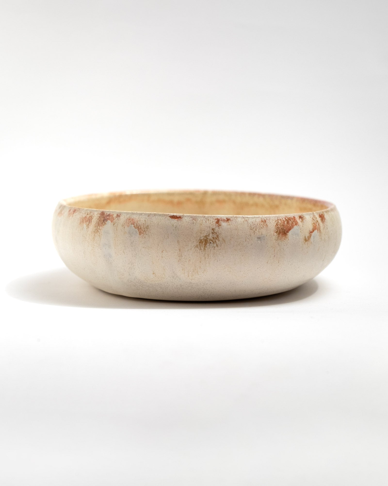 Ceramic bowl with a rustic finish on a white background, handmade in Italy