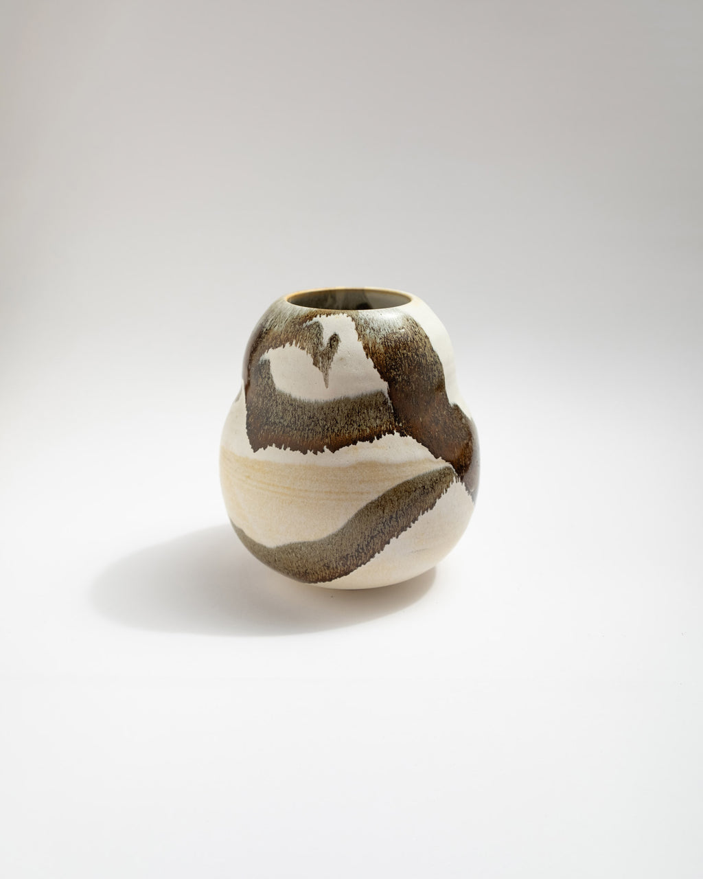 Ceramic white vase with a unique brown pattern on a white background