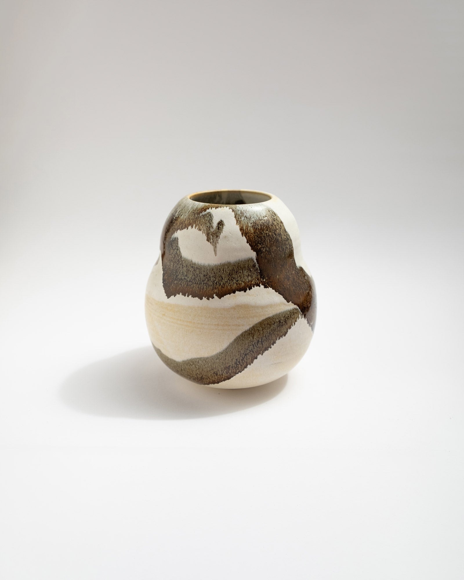 Ceramic white vase with a unique brown pattern on a white background