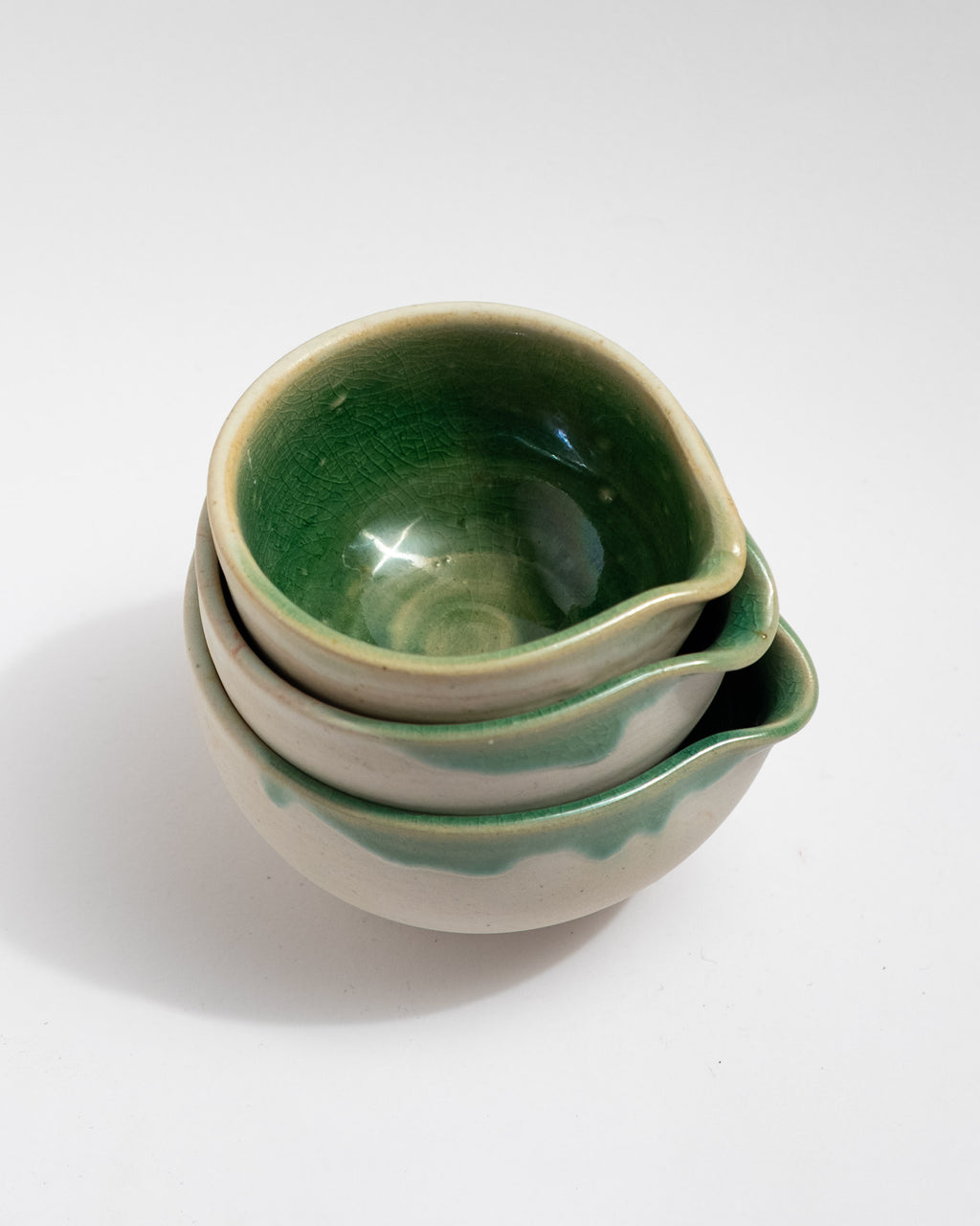 Stack of green ceramic bowls on a white background, handmade in Italy, matcha bowl