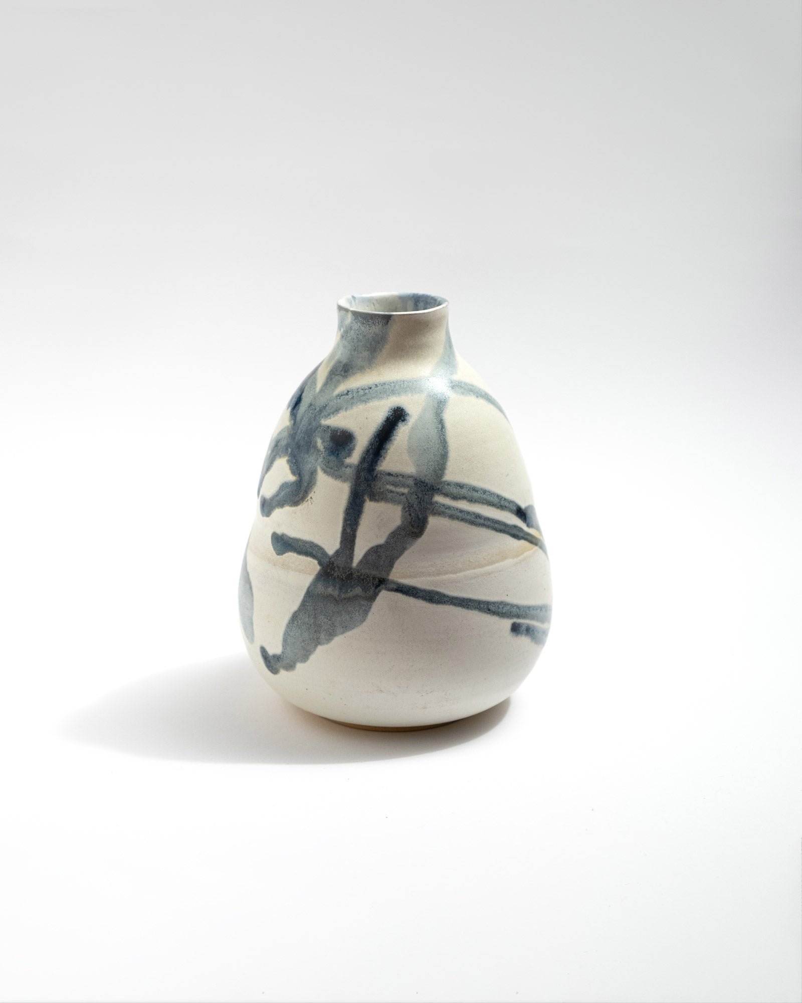 Ceramic vase with abstract blue design on a white background