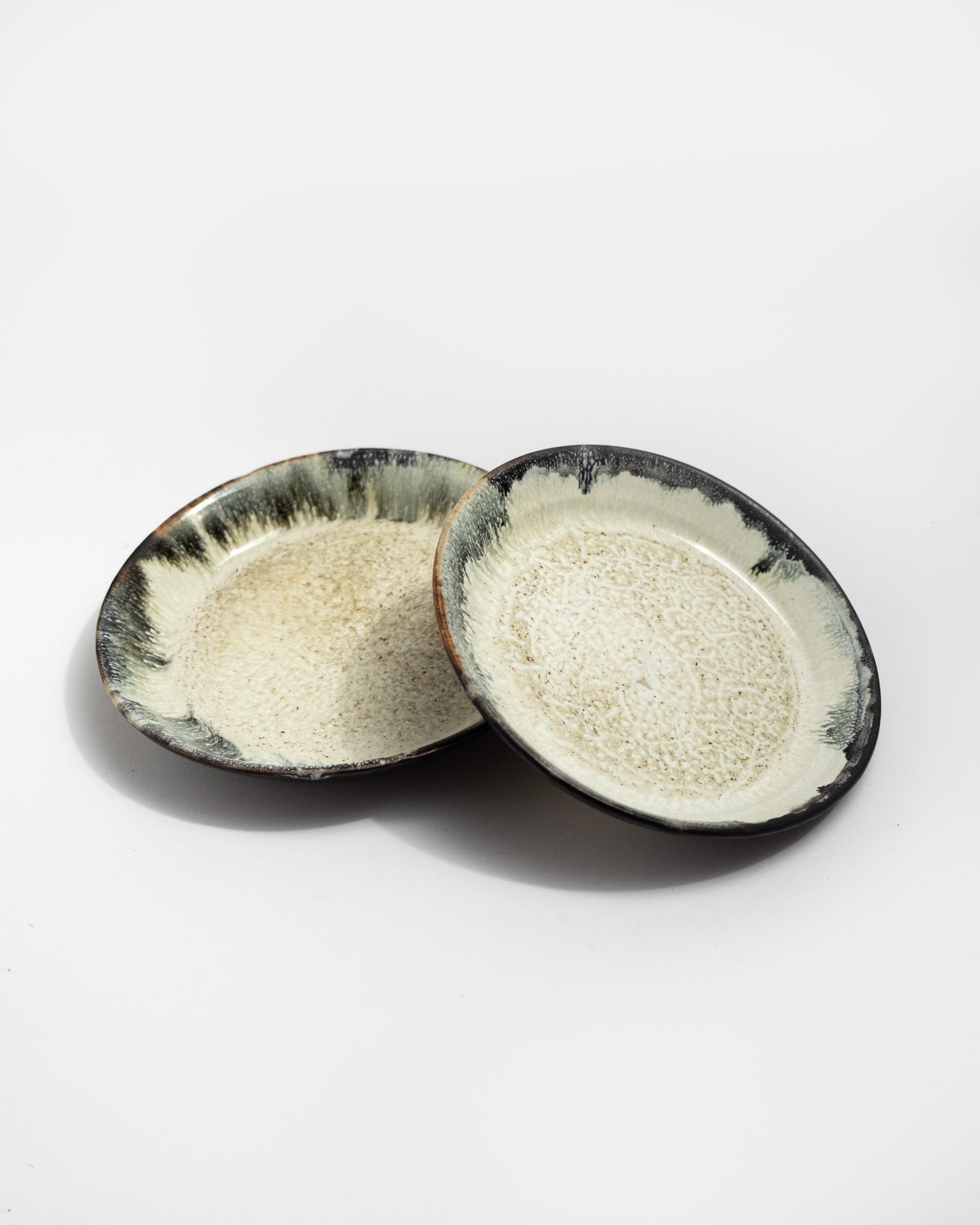 Two ceramic plates with textured surfaces on a white background, handmade in Italy, Christmas gift