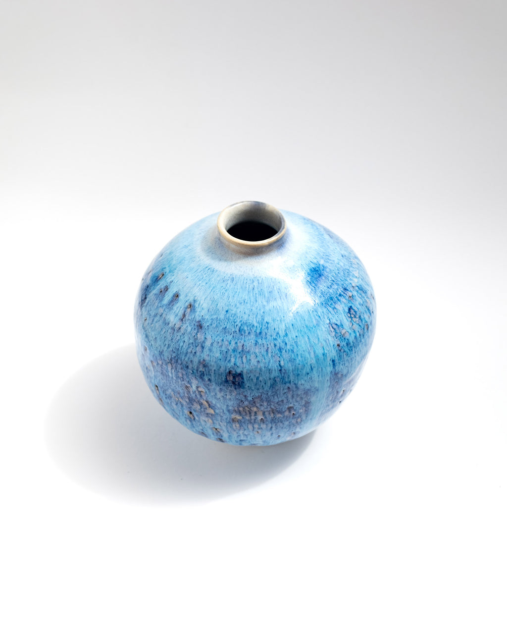Blue ceramic vase on a white background, handmade in Rome, Italy