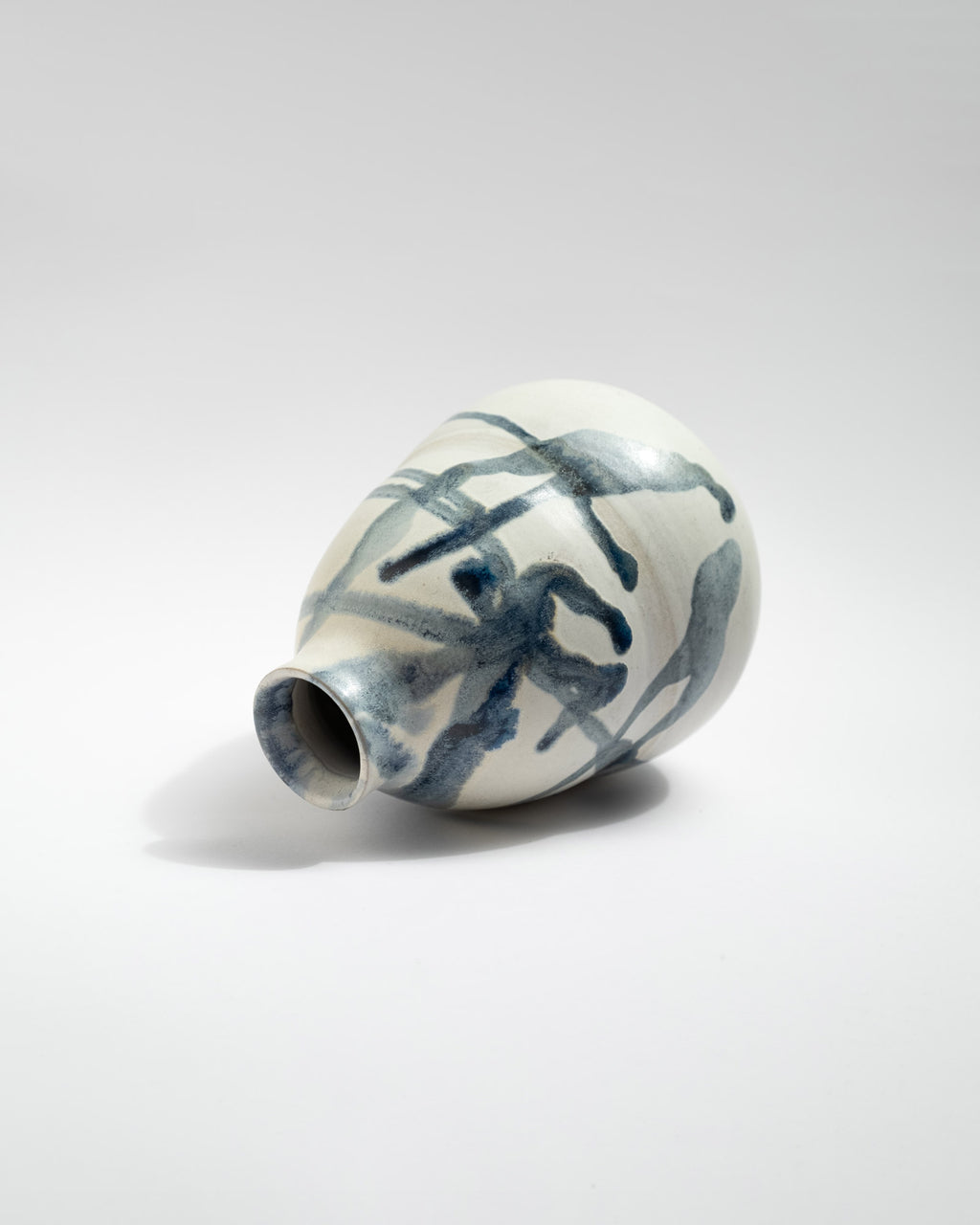 Ceramic vase with blue abstract patterns on a white background