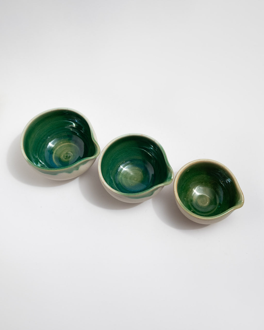 Three green ceramic bowls, handmade in Italy