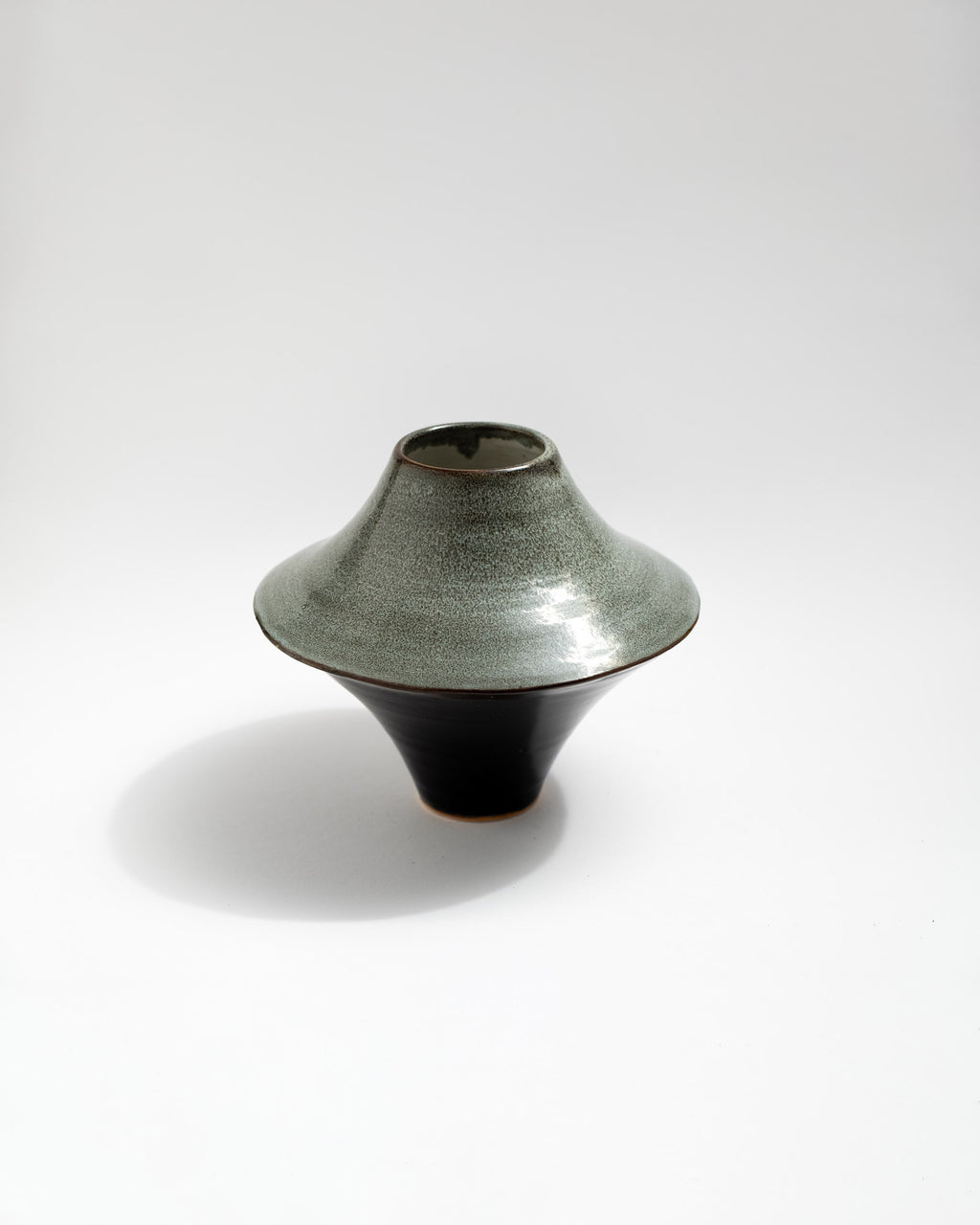 Unique ceramic vase with textured surface on a white background, handmade in Italy