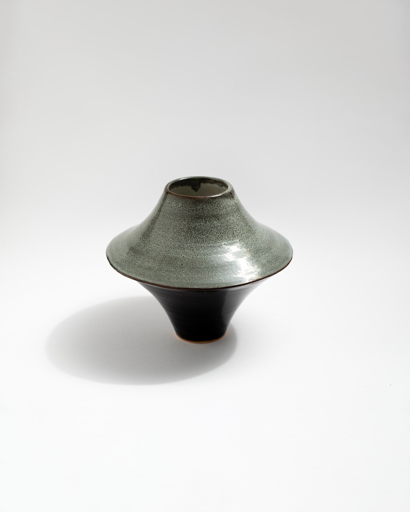 Unique ceramic vase with textured surface on a white background, handmade in Italy