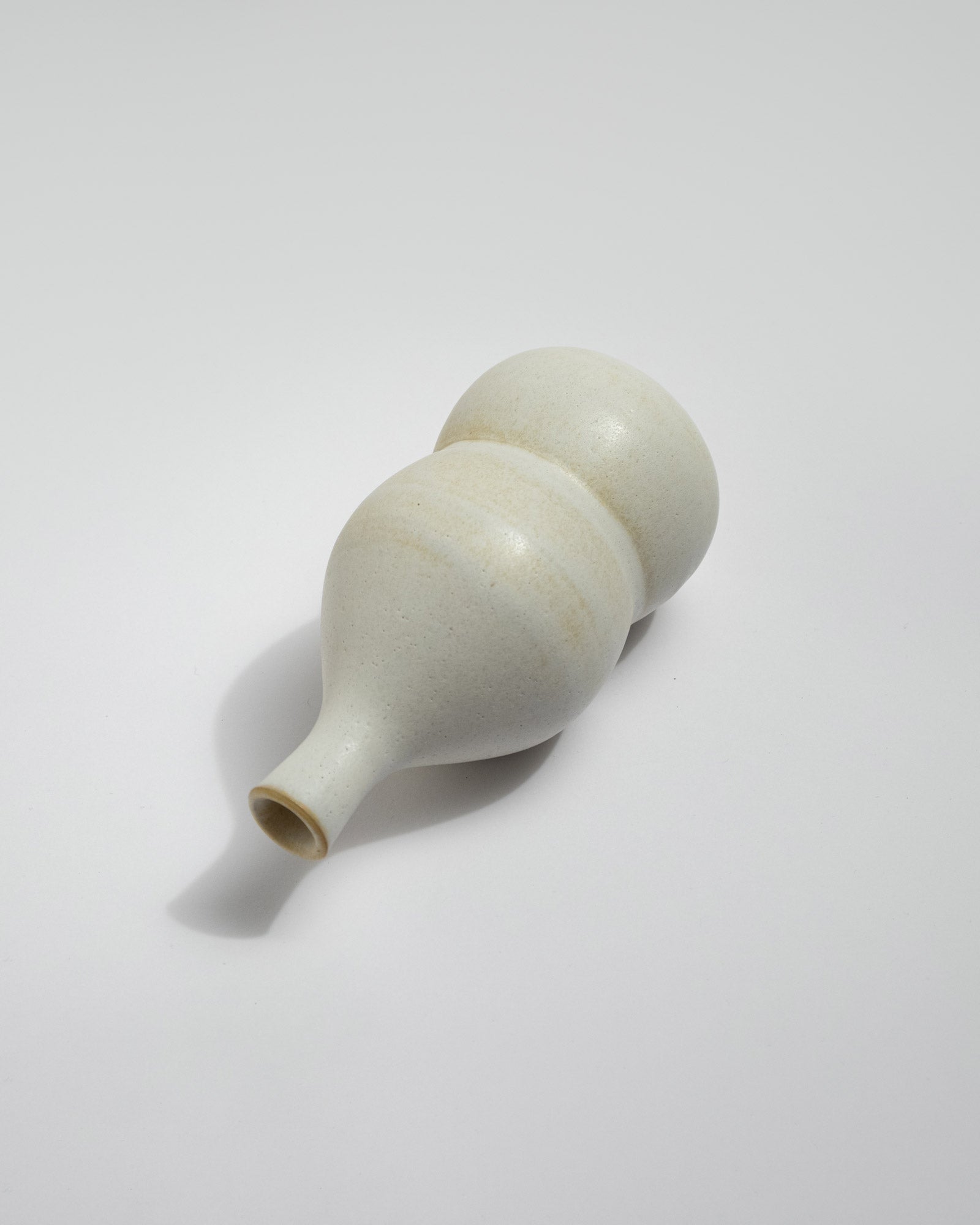 White ceramic vessel on a light gray background