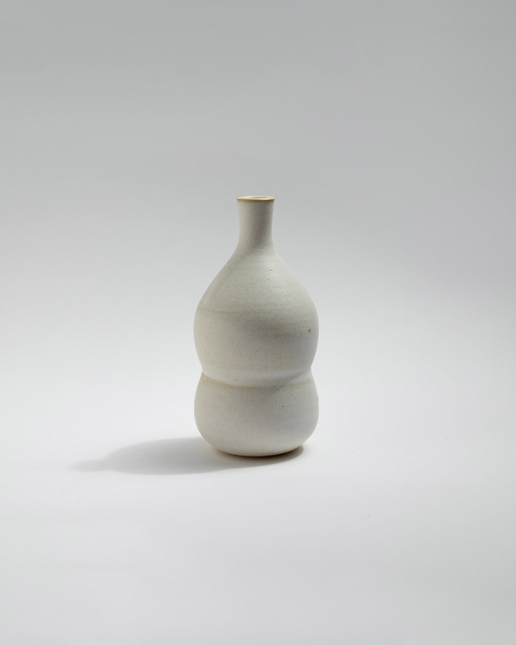 White ceramic vase on a light gray background