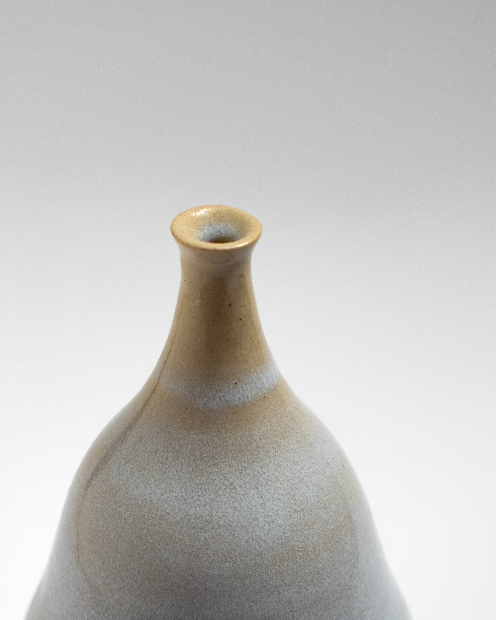 Handmade pear-shaped ceramic vase with soft grey and beige gradient glaze