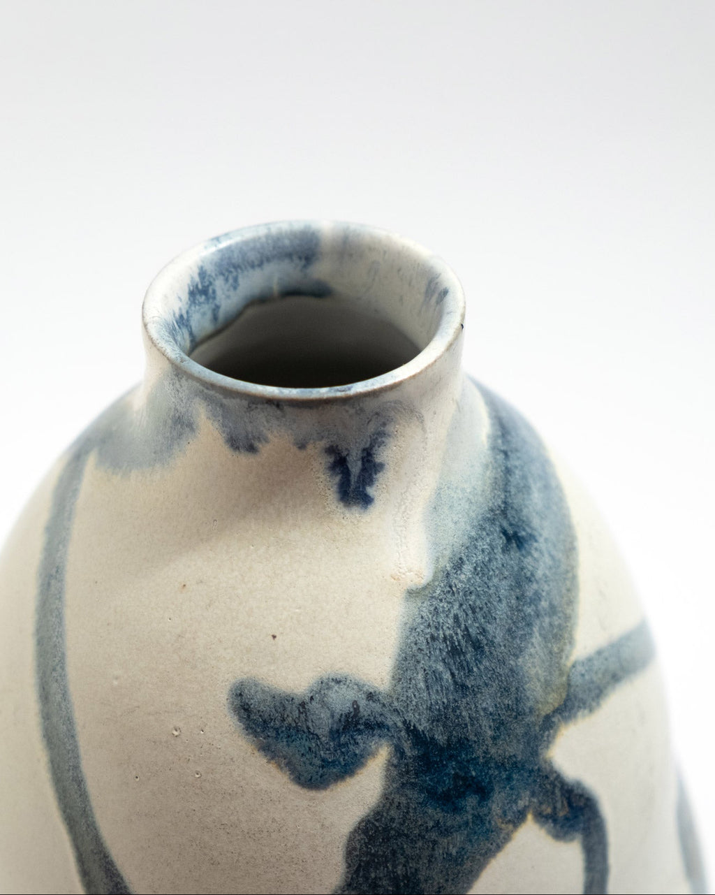Ceramic vase with blue abstract patterns on a white background