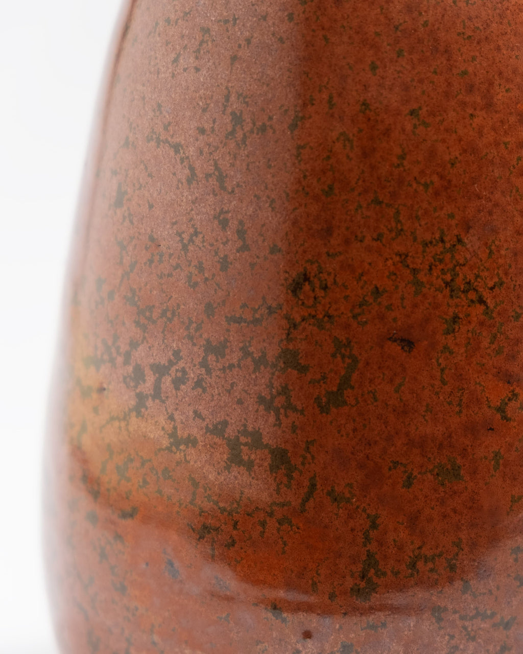 Close-up of a textured brown glaze with speckles