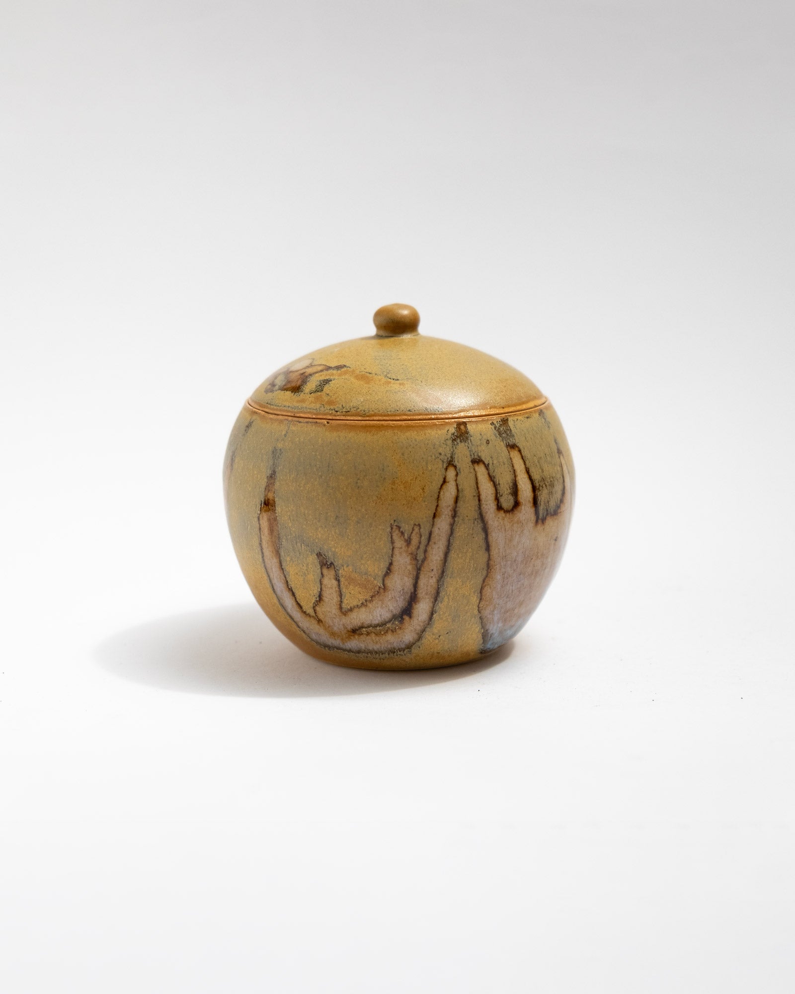 Handmade ochre stoneware lidded jar with natural firing patterns
