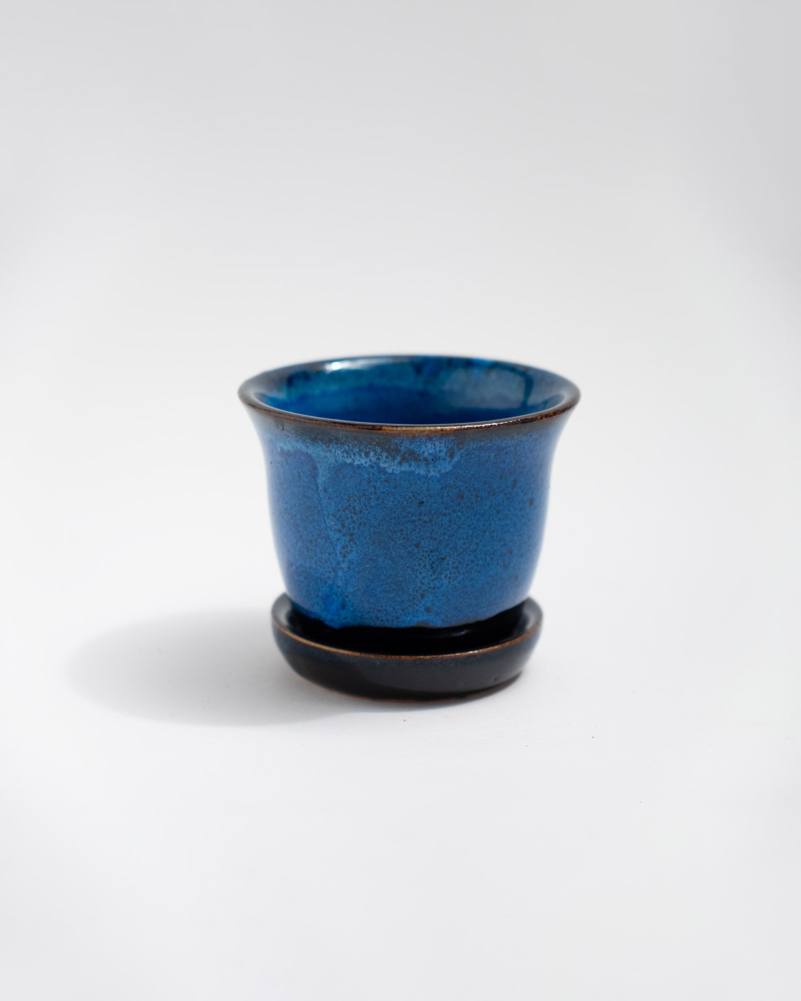 Small handmade cobalt-blue stoneware planter with matching saucer