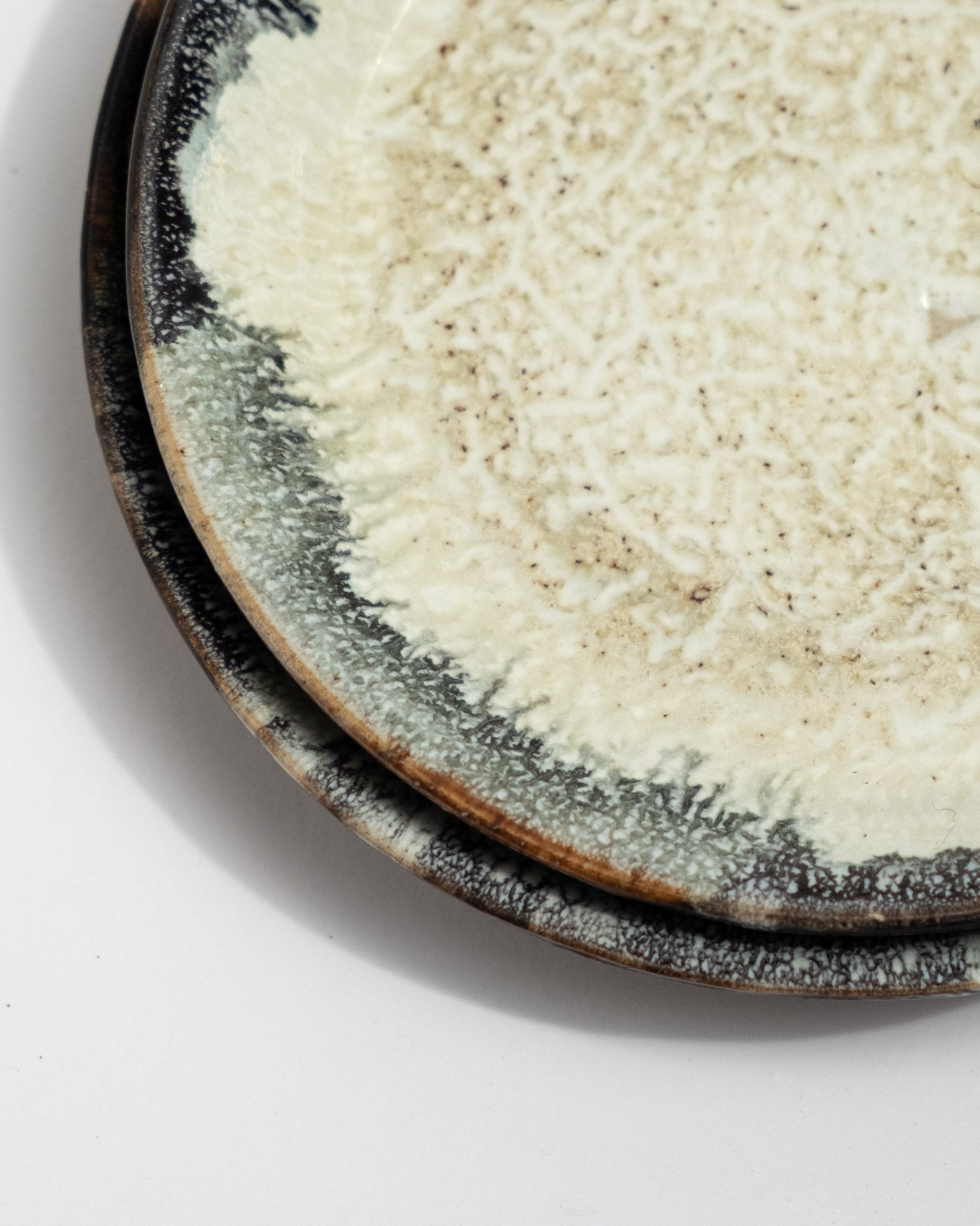 Close-up of a textured ceramic plate, speckled ceramic plates