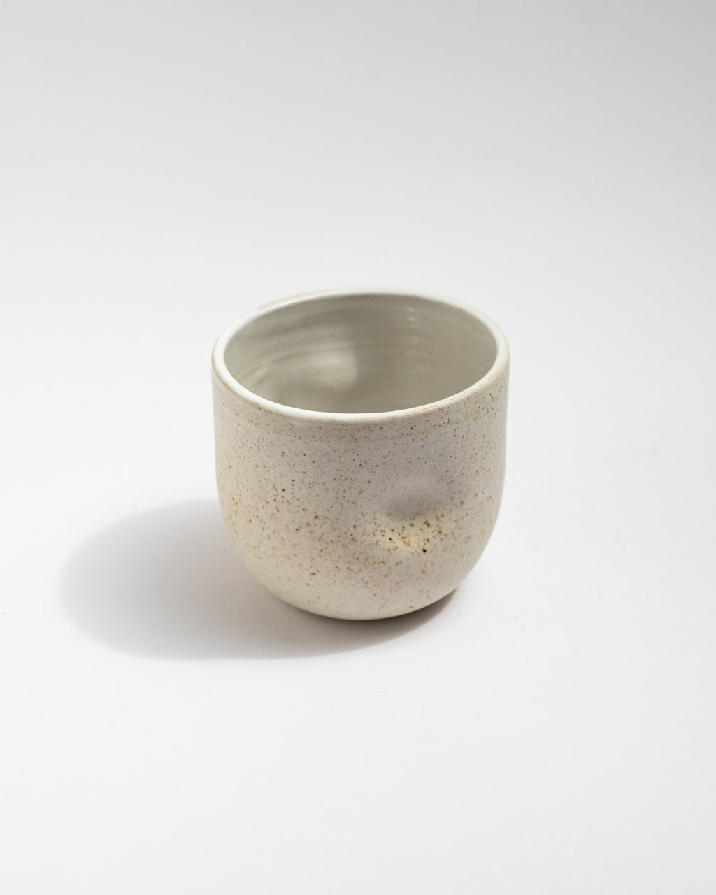  ivory speckled stoneware cup with soft cylindrical shape