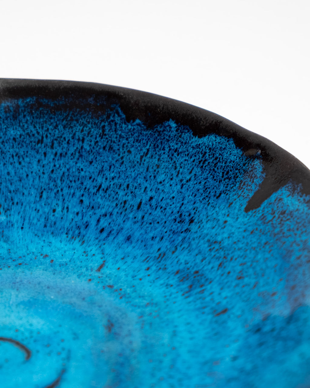 stoneware bowl with a glossy turquoise and deep-blue glaze