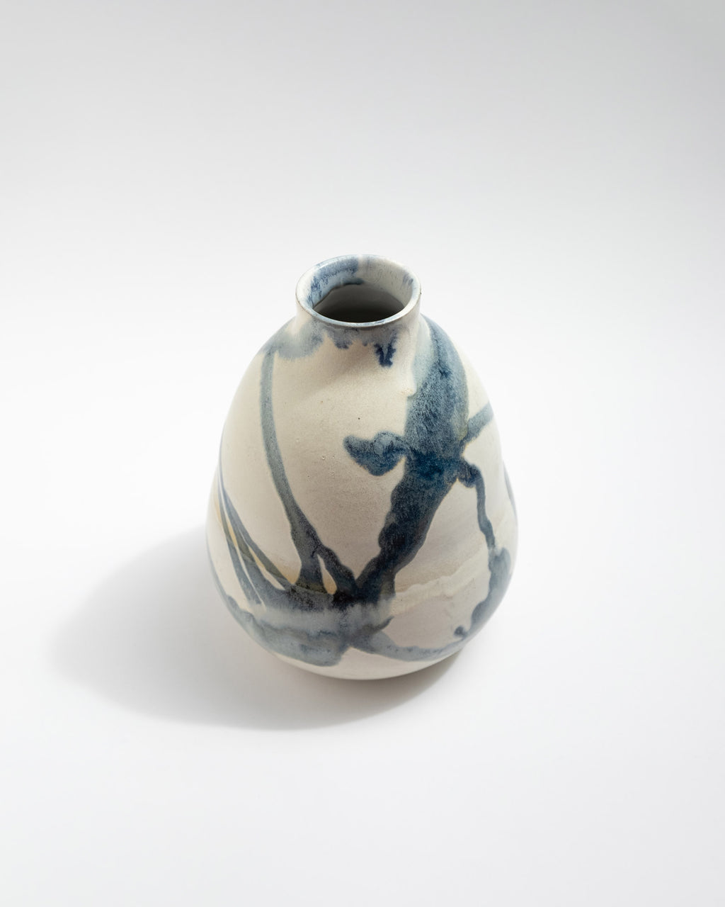 Ceramic vase with blue abstract design on a white background