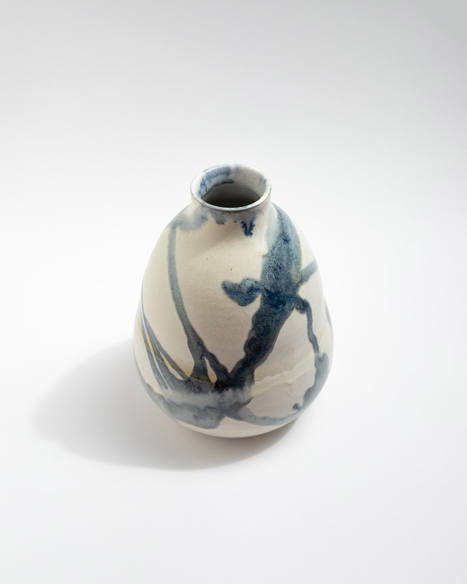 Ceramic vase with blue abstract design on a white background
